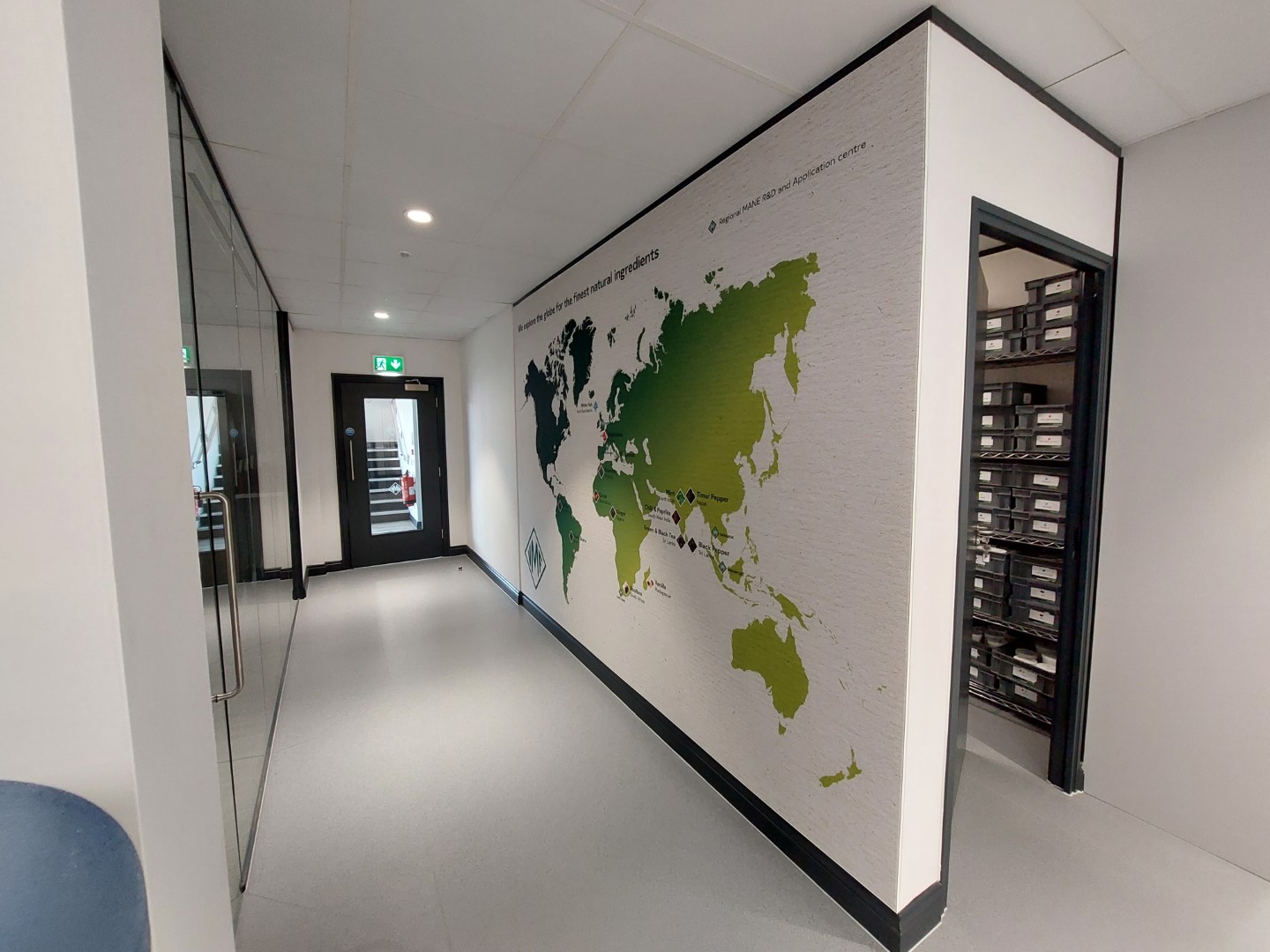a corridor with a world map on the wall